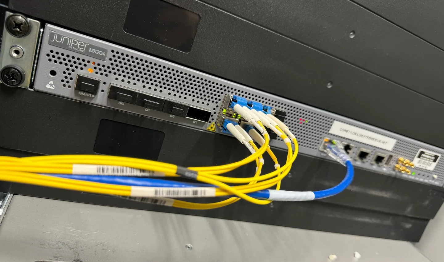 A racked Juniper MX204 with connected fibre cables at FyfeWeb's Equinix LD8 installation