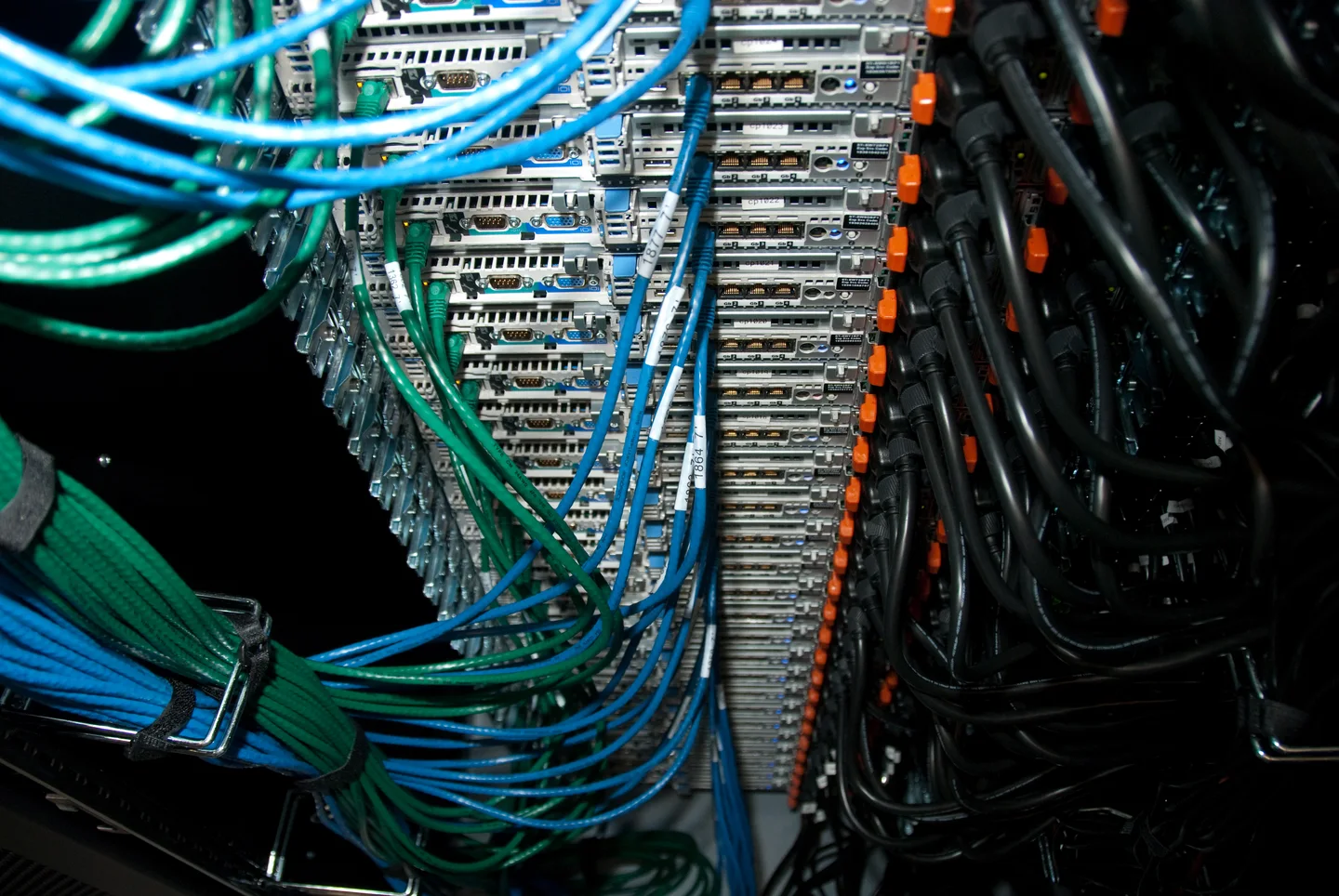 Rear of a Wikimedia EQIAD server rack with labelled network and power cables