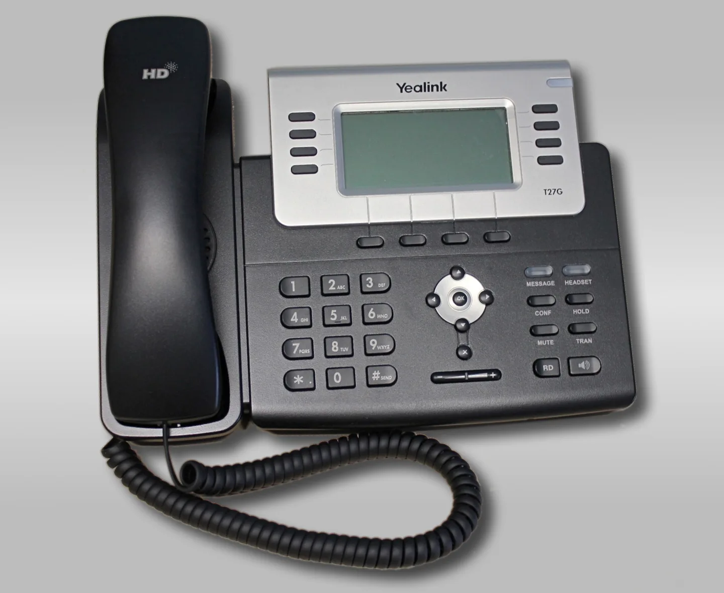 Yealink T27G desk telephone with its numbered keypad, display, handset and coiled cord